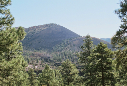 [Dark cone of a mountain covered with ash.]